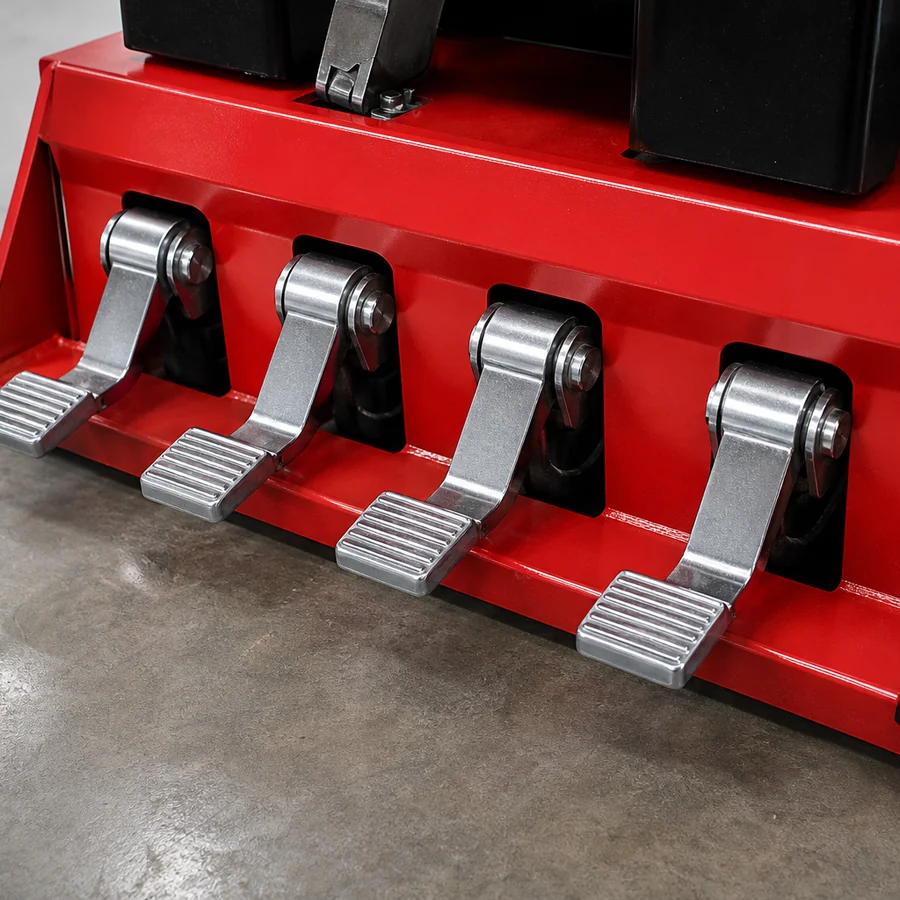Chrome foot pedals at the base of a red tire changer